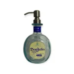 Don Julio Dispenser is made in a traditional tequila-round small bottle with aquamarine glass. The label is silver and cream with navy writing. The pump is silver.